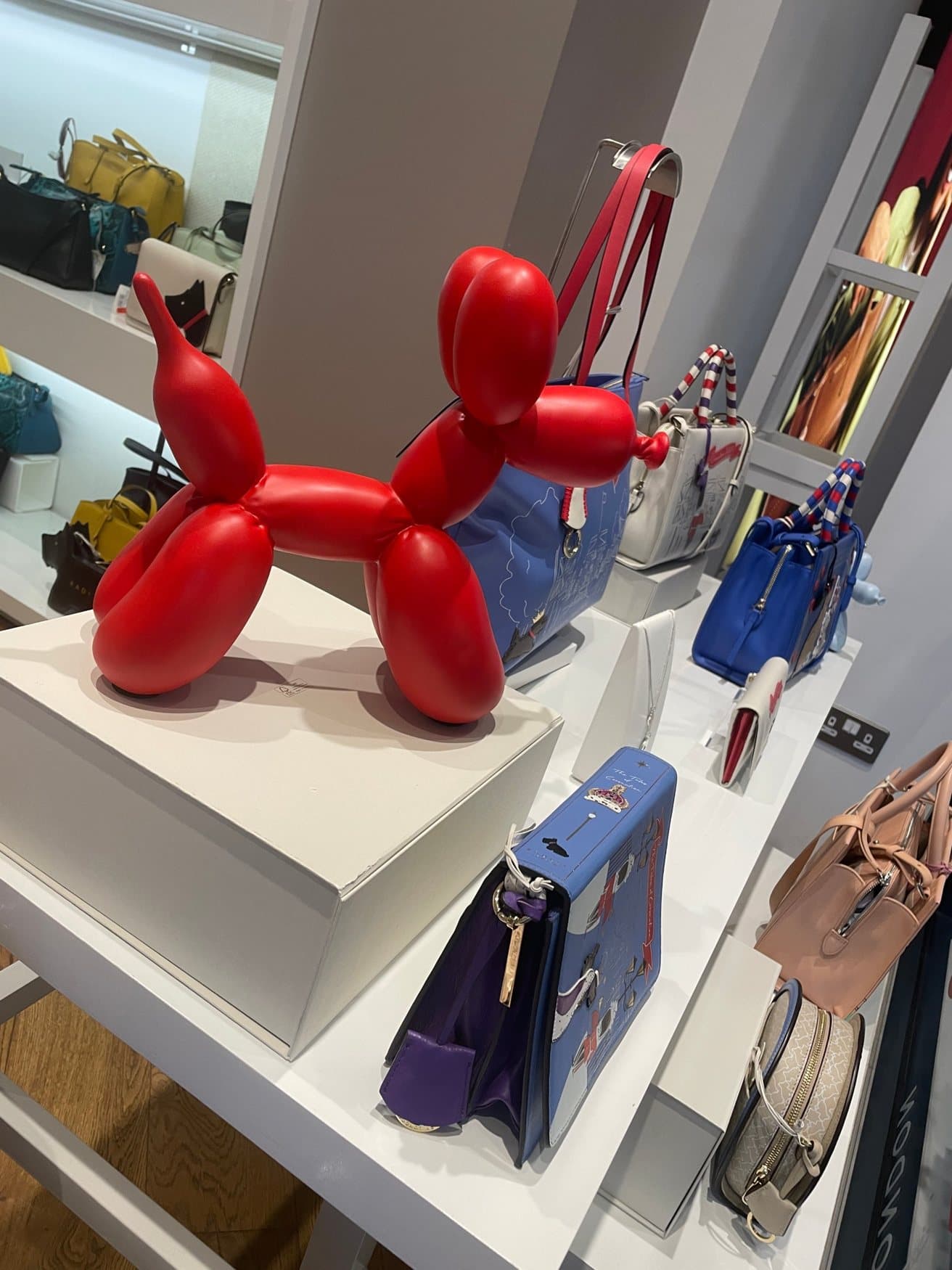Red balloon dog on display in a London store