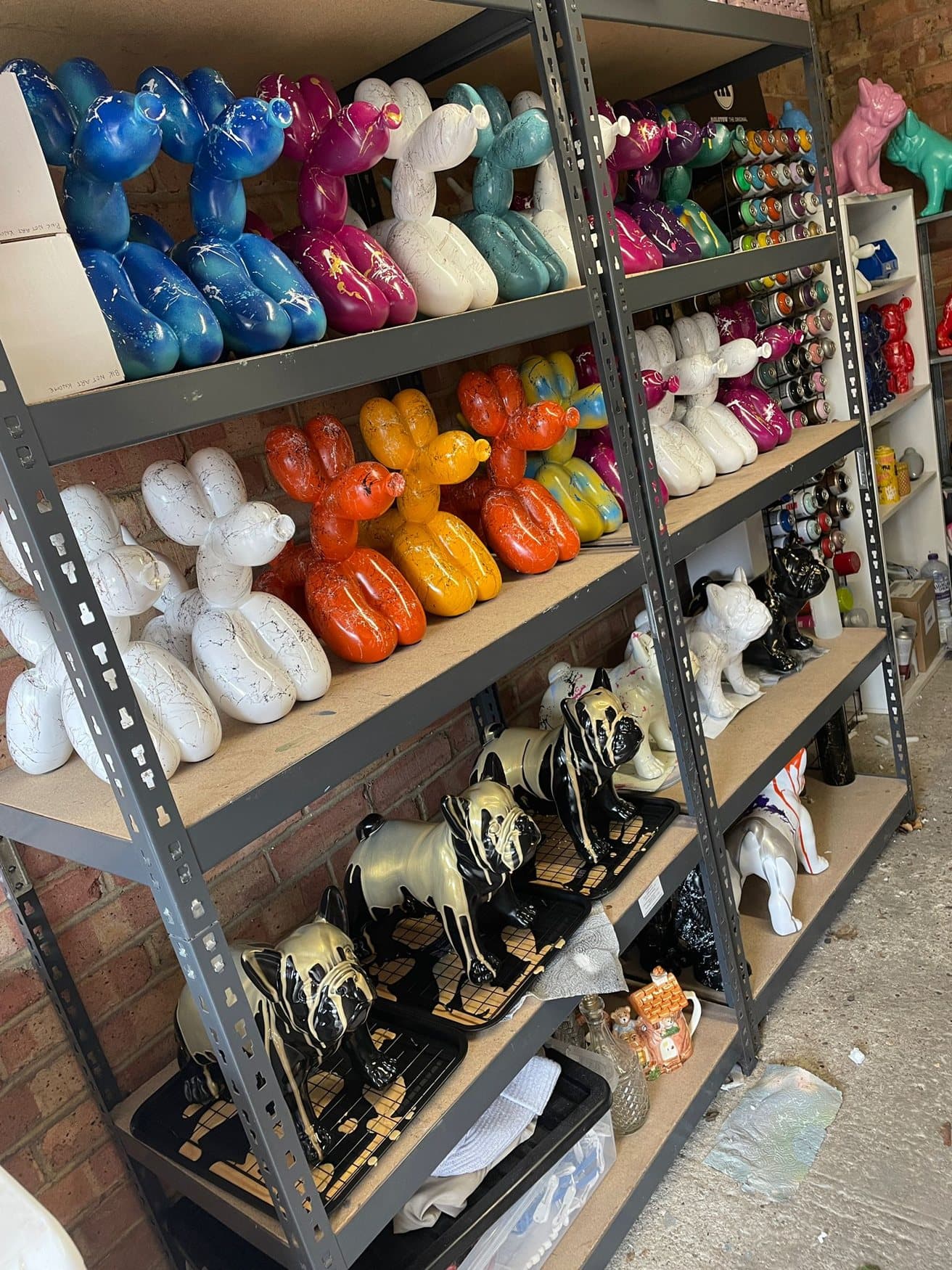 Shelves of finished balloon dogs in marble and splatter finishes